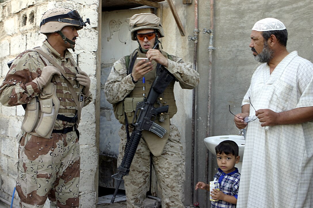 FALLUJAH, Iraq - Lance Cpl. Dan Williams, an intelligence analyst with 1st Battalion, 6th Marine Regiment, jots down census information on a local household while conducting a mission alongside fellow Marines and Iraqi Security Forces.  The 24-year-old Murrysville, Penn. native is currently deployed to Iraq's Al Anbar province, where he assists his Camp Lejeune, N.C.-based unit acquire information on insurgent whereabouts.