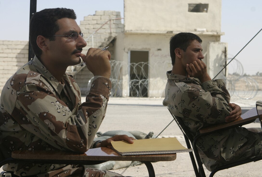 FALLUJAH, Iraq - Iraqi soldiers listen to an infantry skills class 1st Battalion, 6th Marine Regiment's Iraqi Security Forces training cadre delivered here Aug. 2.  Since mid-March, battalion personnel have trained approximately 600 Iraqi personnel on topics such as first aid in combat, infantry tactics, and convoy driving skills.  Iraqi forces are fully integrated into every operation the battalion's Marines and sailors conduct in and around the city.