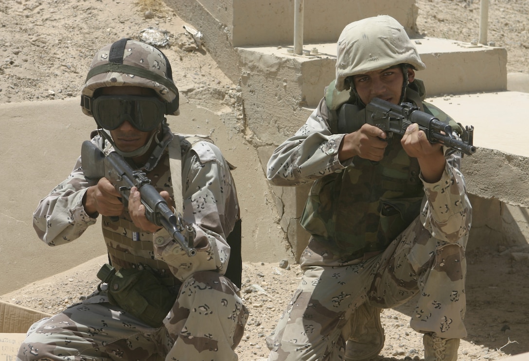 FALLUJAH, Iraq - Iraqi soldiers provide security around a structure during a training evolution 1st Battalion, 6th Marine Regiment's Iraqi Security Forces training cadre personnel supervised here August 2.  Since mid-March, battalion personnel have trained approximately 600 Iraqi personnel on topics such as first aid in combat, infantry tactics, and convoy driving skills.  Iraqi forces are fully integrated into every operation the battalion's Marines and sailors conduct in and around the city.