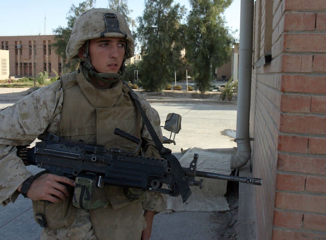 AL QA'IM, Iraq (Sept. 2, 2005) -- Bailuiton, Ala., native Lance Cpl. David E. Jones, squad automatic weapons gunner, 2nd Platoon, Company K, 3rd Battalion, 2nd Marine Regiment, 2nd Marine Division provides security during a cordon and knock mission at a nearby cement factor.  (Official U.S. Marine Corps photo by Sgt. Jerad W. Alexander)