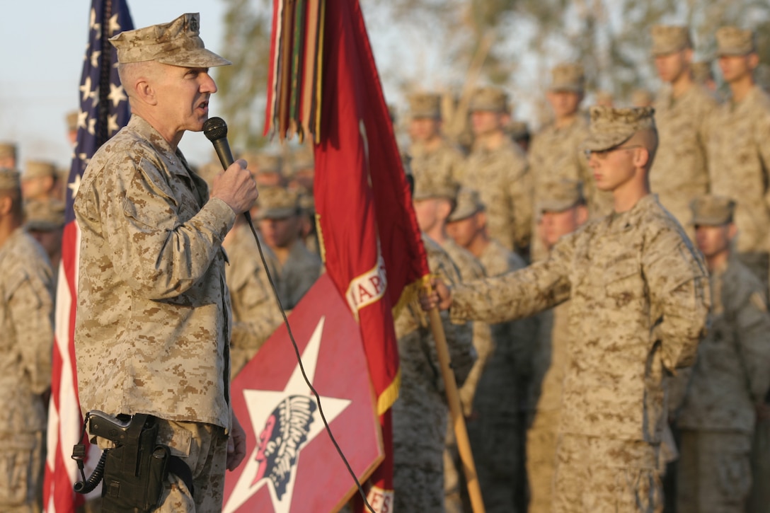 CAMP BAHARIA, Iraq - Major General Richard Huck, 2nd Marine Division's commanding general, speaks to the Marines and sailors of 1st Battalion, 6th Marine Regiment during a reenlistment ceremony here Oct. 2.  Altogether, the 45 personnel reenlisting received approximately one million dollars in reenlistment bonuses, along with future duty station preferences.