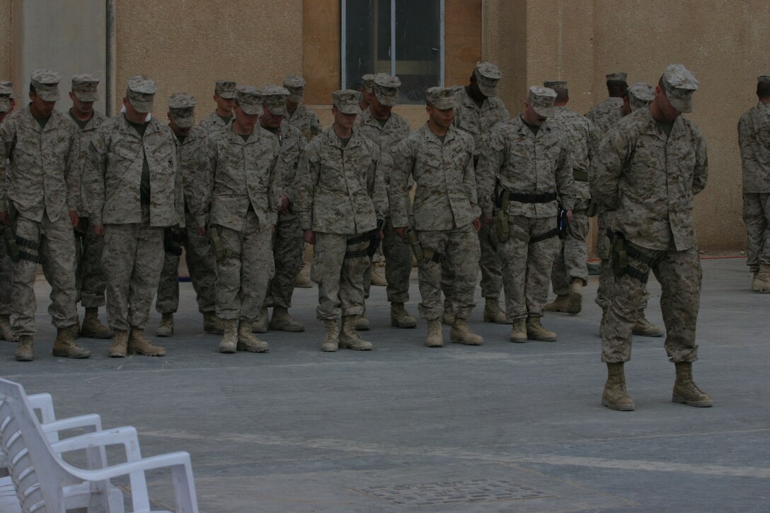 CAMP AL QA'IM, Iraq (March 22, 2005)- Marines with the security platoon of 3rd Battalion, 2nd Marine Regiment pray for their fallen brother Lance Cpl. Kevin Smith who was killed in action by a vehicle borne improvised explosive device March 21. The Memorial ceremony took place here March 22. Official U.S. Marine Corps photo by Lance Cpl. Lucian Friel (RELEASED)