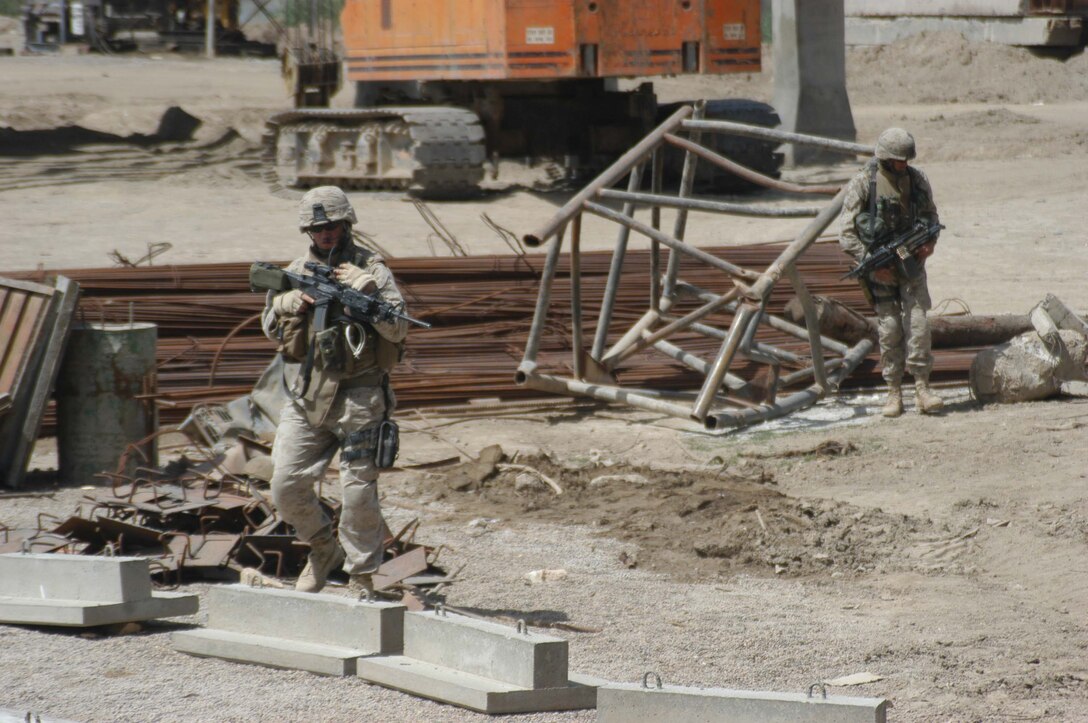 AR RAMADI, Iraq (April 2, 2005) - Marines with 4th Platoon, Company B, 1st Battalion, 5th Marines, patrol an area on the outskirts of the city here during a weapons caches search. Marines with 4th Platoon, Company B, 1st Battalion, 5th Marine Regiment and leathernecks of Company A, 1st Combat Engineer Battalion teamed up and discovered four 120 mm shells, a 155 mm shell; several live and empty 7.62 rounds, explosive detonation cord, a live fragmenting grenade and one rocket launcher during a five-hour search conducted on several acres of farmland along the banks of the Euphrates River on the edge of the city. Photo by Cpl. Tom Sloan