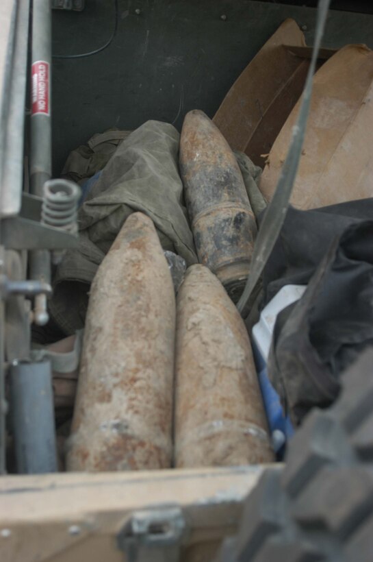 AR RAMADI, Iraq (April 2, 2005) - The back compartment of a Humvee holds part of the day's find during a weapons caches sweep of an area on the outskirts of the city here. Along with these three 120 mm shells, Marines with 4th Platoon, Company B, 1st Battalion, 5th Marine Regiment and leathernecks of Company A, 1st Combat Engineer Battalion also discovered a 155 mm shell; several live and empty 7.62 rounds, explosive detonation cord, a live fragmenting grenade and one rocket launcher when they teamed up and conducted a five-hour search across several acres of farmland along the banks of the Euphrates River on the edge of the city. Photo by Cpl. Tom Sloan.