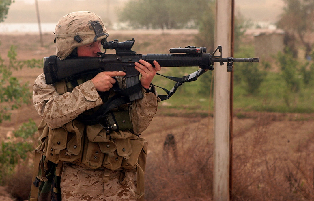 AR RAMADI, Iraq -- Lance Corporal Isaiah Schaeffer, a 20-year-old team leader in 3rd squad, patrols the town as the rest of Camp Blue Diamond's quick reaction force hand out stuffed animals and soccer balls to Iraqi children, April 3.  Schaeffer is a Fredricksburg, Va. native and 2002 graduate of Chancellor High School.  U.S. Marine Corps photo by Sgt. Stephen D'Alessio (RELEASED)