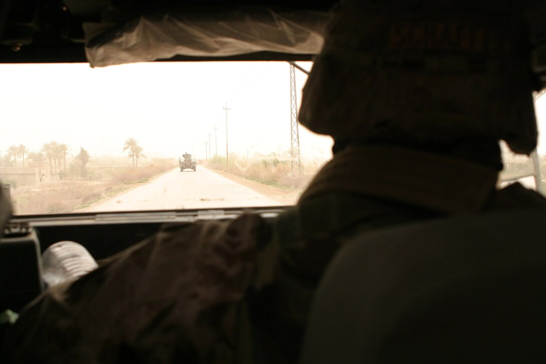 AR RAMADI, Iraq -- Marines with Camp Blue Diamond's quick reaction force patrol throgh the town to hand out stuffed animals and soccer balls to Iraqi children, April 3.  The friendship patrol aimed to maintain good relations with the citizens.  U.S. Marine Corps photo by Sgt. Stephen D'Alessio (RELEASED)
