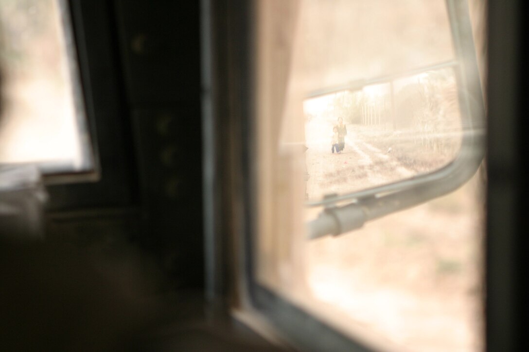 AR RAMADI, Iraq -- Iraqi children follow a convoy of Marines with Camp Blue Diamond's quick reaction force, who handed out stuffed animals and soccer balls to them, April 3.  U.S. Marine Corps photo by Sgt. Stephen D'Alessio (RELEASED)