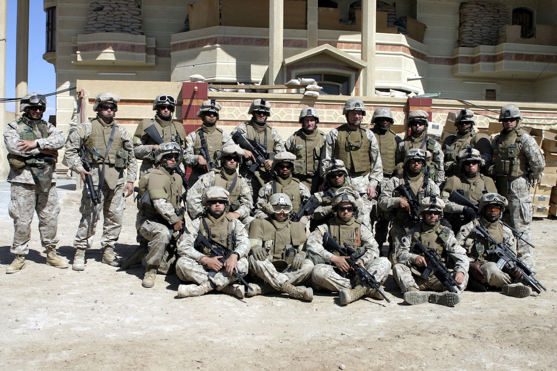 FALLUJAH, Iraq - Mario Franco, an interpreter with 1st Battalion, 6th Marine Regiment, far left, stands beside the battalion commander's Personal Security Detail here April 5.  Franco, a 32-year-old Baghdad native, is a combat veteran who has served with four U.S. military units in the area since 2004, and currently works as the battalion commander's interpreter.