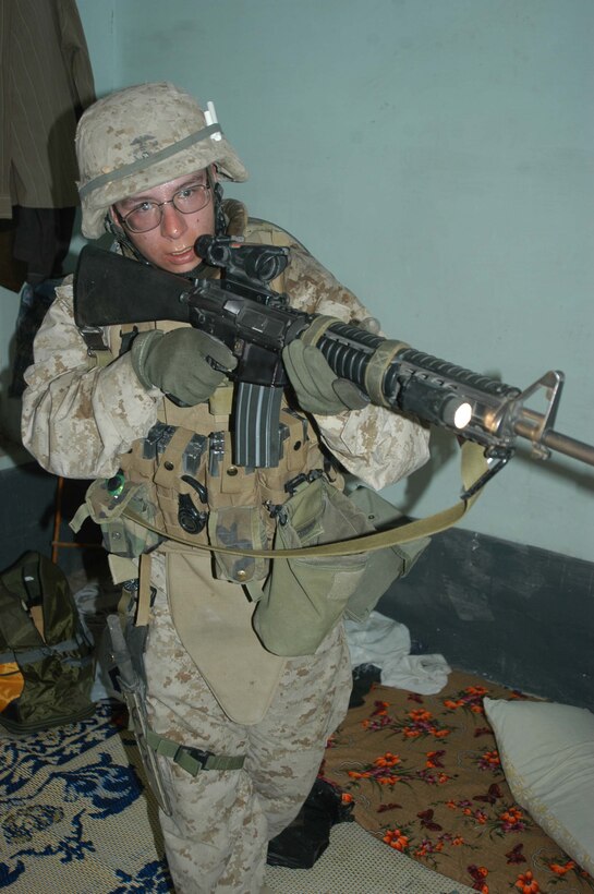 AR RAMADI, Iraq (April 24, 2005) - Lance Cpl. Aaron C. Cardenas, a rifleman with 2nd Squad, 3rd Platoon, Company A, 1st Battalion, 5th Marine Regiment, clears a dark room in a building here he and his Marines are searching. The 21-year-old from Monterey Park, Calif., and his fellow 3rd Platoon warriors cordoned off a two-block radius of Company A's area of operations and conducted a detailed search of its buildings and residents. The Marines didn't encounter any insurgents or threats during their three-hour-mission and returned safely to their firm base at Camp Hurricane Point without incident. Photo by Cpl. Tom Sloan