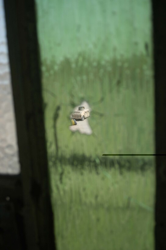 AR RAMADI, Iraq (April 24, 2005) - A bullet hole in a window belonging to a room on the upper level of a four-story apartment complex reveals the scene where Marines with 1st Battalion, 5th Marine Regiment, engaged a sniper at his position. Photo by Cpl. Tom Sloan