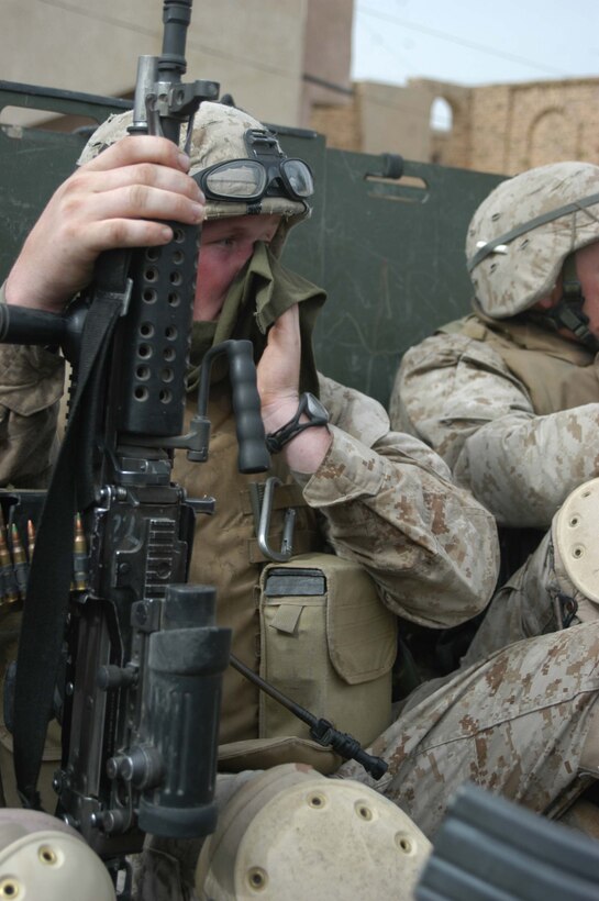 AR RAMADI, Iraq (April 24, 2005) - Sitting in the back of a 7-ton truck, Lance Cpl. Jesse H. McClellan, a squad automatic machine gunner with 2nd Squad, 3rd Platoon, Company A, 1st Battalion, 5th Marine Regiment, wipes sweat from his face after finishing a search mission in the city here with his comrades. The 20-year-old from Borger, Texas, and his fellow 3rd Platoon warriors cordoned off a two-block radius of Company A's area of operations and conducted a detailed search of its buildings and residents. The Marines didn't encounter any insurgents or threats during their three-hour-mission and returned safely to their firm base at Camp Hurricane Point without incident. Photo by Cpl. Tom Sloan