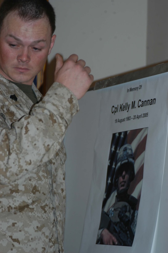 CAMP HURRICANE POINT, Ar Ramadi, Iraq (April 25, 2005) - Sergeant Erik D. Sphoon, guide for st Platoon, Company A, 1st Battalion, 5th Marine Regiment, has an emotional moment and looks away from a picture of his comrade, Cpl. Kelly M. Cannan, who fell on the battlefield here April 20. Marines with 1st Battalion, 5th Marine Regiment, held a dual memorial ceremony in honor of Cannan, 21, of Lowville, N.Y., and Lance Cpl. Marty G. Mortenson, 22, of Flagstaff, Ariz. Both warriors were killed by the same improvised explosive device attack while traveling in a convoy. They were on their third deployment supporting Operation Iraqi Freedom. Photo by Cpl. Tom Sloan
