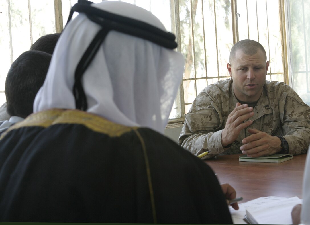 SAQLAWIYAH, Iraq - Capt. Daniel Zappa, Company A, 1st Battalion, 6th Marine Regiment commander, discusses security concerns with assembled members Saqlawiyah's city council.  City leaders such as Saqlawiyah's mayor, chief of police, and numerous tribal sheiks met with Marines and Iraqi forces here to discuss security and civil-military concerns.