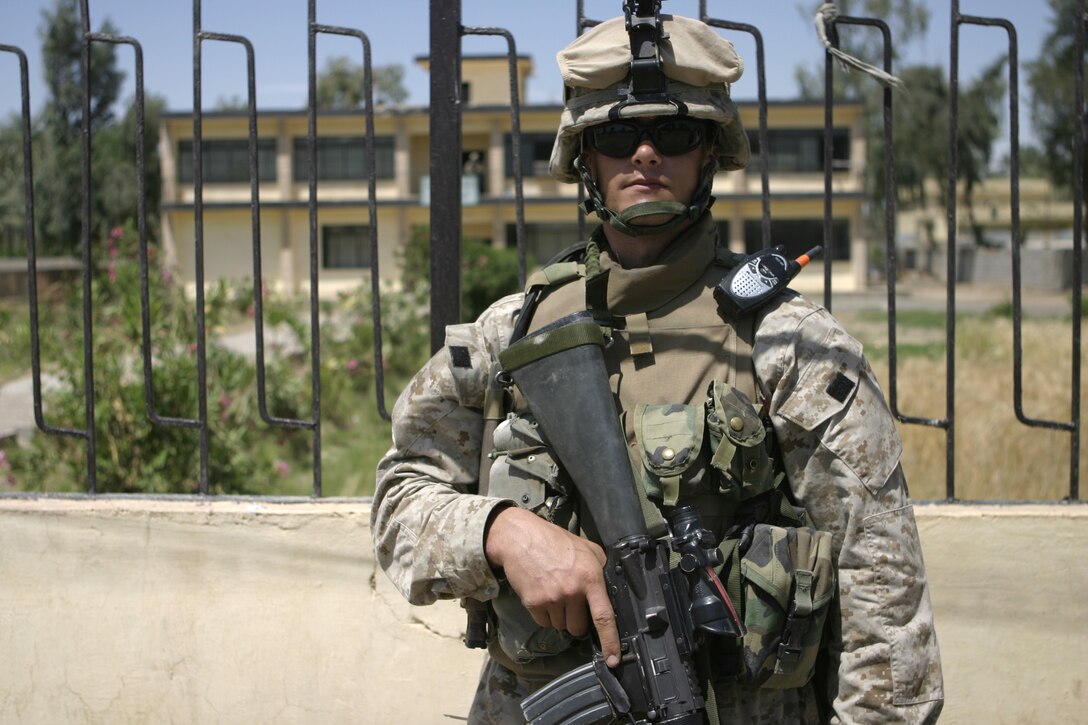 SAQLAWIYAH, Iraq - Pfc. Eric Gunderson, a rifleman with 2nd Platoon, Company A, 1st Battalion, 6th Marine Regiment, provides security outside city hall here April 27.  The 22-year-old Madelia, Minn. native and his unit are currently working with the local security forces to search for illegal weapons and root out remaining insurgents.