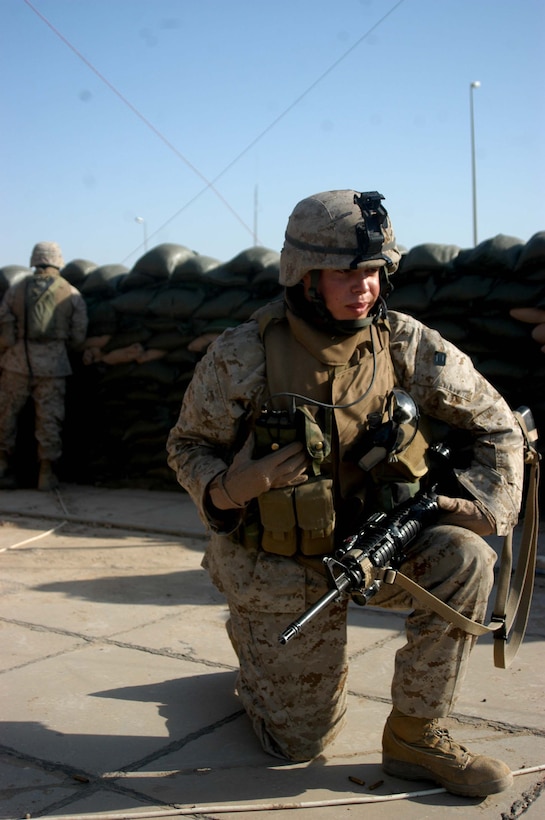 CAMP SNAKE PIT Ar Ramadi, Iraq (May 3, 2005) -- Sergeant Seth D. Hickman, squad leader of 1st Squad, 2nd Platoon, Company C, 1st Battalion, 5th Marine Regiment, communicates with his fellow Marines on his radio while taking sporadic gunfire from insurgents here. The Mason City, Iowa, native celebrated part of his 24th birthday on the top of his Company C's command operations center building engaging insurgents with his weapon. Insurgents attacked the company's firm base with small arms fire a few minutes past 8 a.m. The warriors successfully defended their camp from the attack and fought of the terrorists. Photo by Cpl. Tom Sloan
