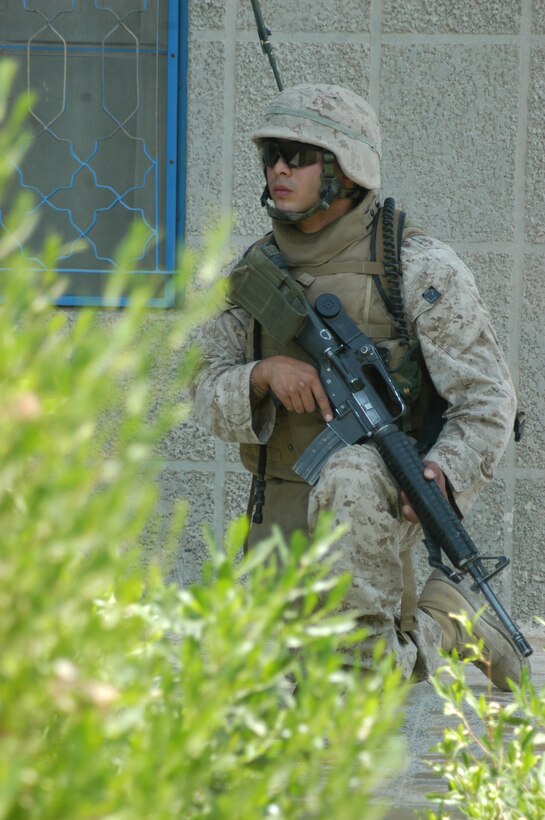 AR RAMADI Iraq (June 3, 2005) -Lance Cpl. Salvador Ramirez, a field radio operator with 1st Squad, 2nd Platoon, Company C, 1st Battalion, 5th Marine Regiment, keeps a vigilant watch from a house here during a mission. The 21-year-old from Chicago, his fellow 1st Squad warriors and seven members of the Iraqi Security Forces conducted a mission to listen to messages a mosque was broadcasting over its loudspeakers during midday prayer. Photo by: Cpl. Tom Sloan