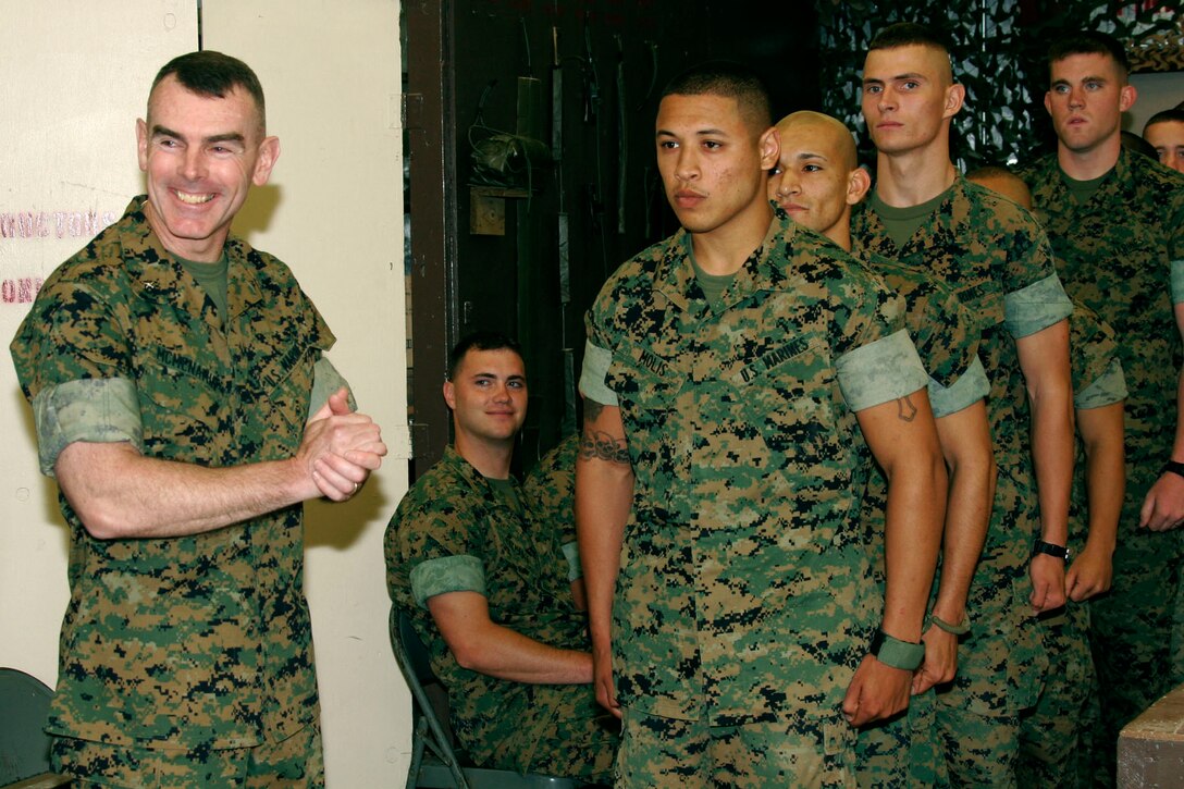 MARINE CORPS BASE CAMP LEJEUNE, N.C. - Thirty-four Marines stand in line to receive their certificates from Brig. Gen. Joseph J. McMenamin, the assistant division commander of 2nd Marine Division.  Class 2-05 graduated from the Sappers Leadership Course here June 3.