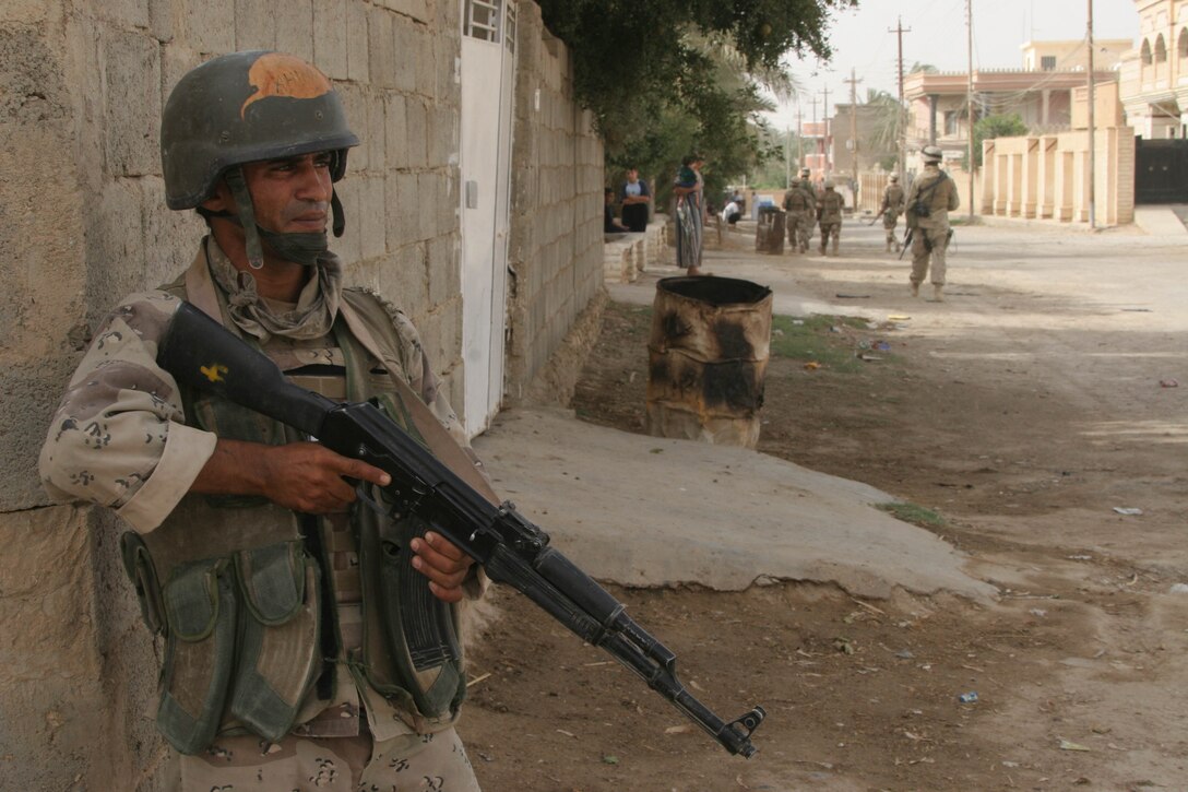HIT, Iraq (July 3, 2005)- Pvt. Ahmed Ali Ubaid, 23, a soldier with the Iraqi Security Forces attached 4th Platoon, Company K, 3rd Battalion, 25th Marine Regiment, Regimental Combat Team-2 helps cordon off an area during Operation Guardian Sword conducted to clear the city and set-up Iraqi Security Forces firm bases through out the city. (Official USMC photo by Lance Cpl. Lucian Friel )(NOT RELEASED)
