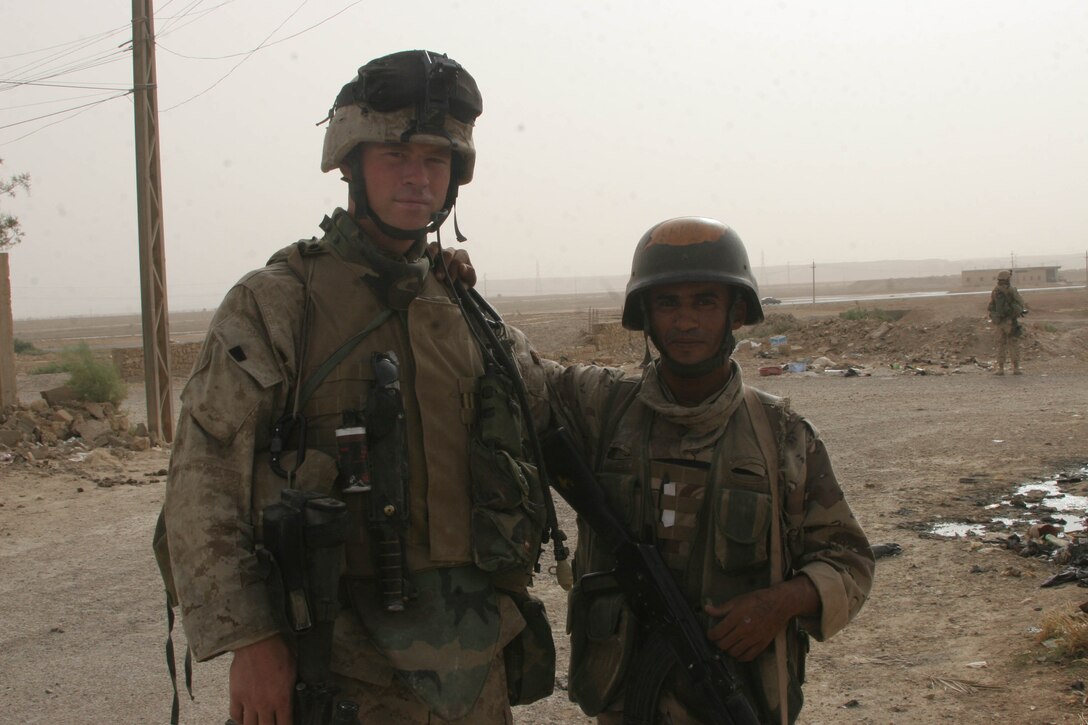 HIT, Iraq (July 3, 2005)- Pvt. Ahmed Ali Ubaid, 23, a soldier with the Iraqi Security Forces attached 4th Platoon, Company K, 3rd Battalion, 25th Marine Regiment, Regimental Combat Team-2 and his team leader Lance Cpl. Matthew W. McGuire worked together to clear the streets during Operation Guardian Sword conducted to clear the city and set-up Iraqi Security Forces firm bases through out the city. (Official USMC photo by Lance Cpl. Lucian Friel )(NOT RELEASED)