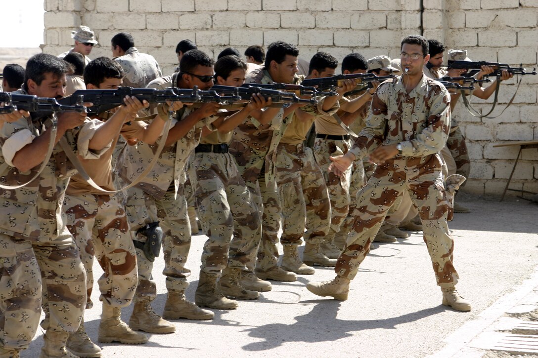 FALLUJAH, Iraq - Private Sayf Jamel Mahdy, an Iraqi soldier teaching alongside 1st Battalion, 6th Marine Regiment's Iraqi Security Forces training cadre, leads his fellow soldiers during marksmanship training exercises here Aug. 3.  Since mid-March, 1st battalion, 6th Marine Regiment personnel have trained approximately 600 Iraqi personnel on topics such as first aid in combat, infantry tactics, and convoy driving skills.  Iraqi forces are fully integrated into every operation the battalion's Marines and sailors conduct in and around the city.