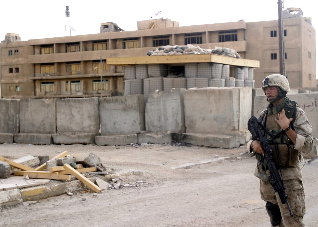 Hit, Al Anbar, Iraq (August 3, 2005)--Cpl. Eric R. Hamilton, 24, of Bemus Point, N.Y. and a fire team leader with 3rd platoon, Company "I", 3rd Battalion, 25th Marines radios in to the firm base as his squad returns.(Official USMC Photo by Corporal Ken Melton)