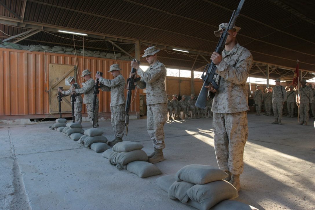 051103-M-2607-001 - Marines from Company E place the down-turned rifles into the sand bags during the Nov. 3, memorial service for the fallen Marines and sailor of 2nd Battalion, 2nd Marine Regiment.