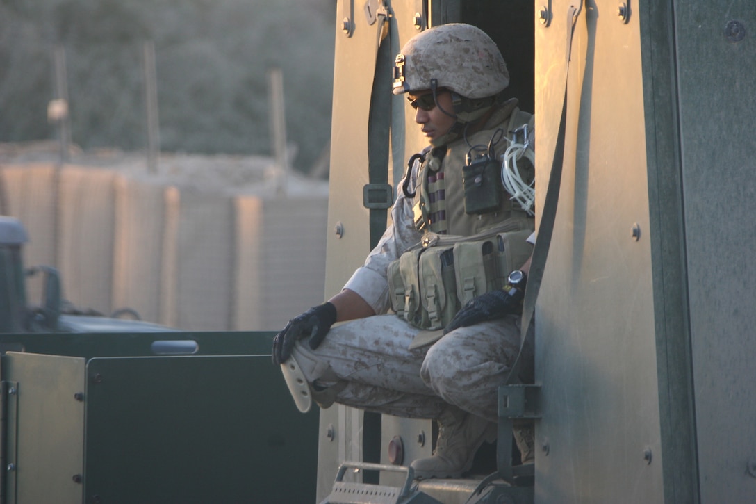 AR RAMADI, Iraq (December 3, 2005) - A Marine with Company L, 3rd Battalion, 7th Marine Regiment, watches the Marines of his company get ready for Operation Shank Dec. 3. Photo by Cpl. Shane Suzuki