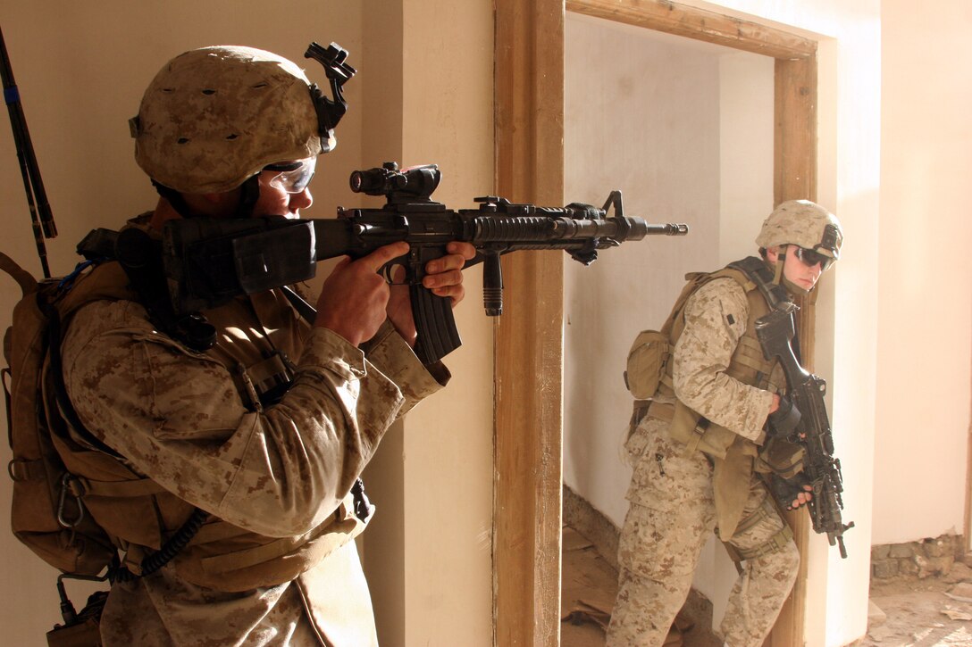 AR RAMADI, Iraq (December 3, 2005) - Two Marines with Company L, 3rd Battalion, 7th Marine Regiment, stands guard during Operation Shank Dec. 3. Photo by Cpl. Shane Suzuki