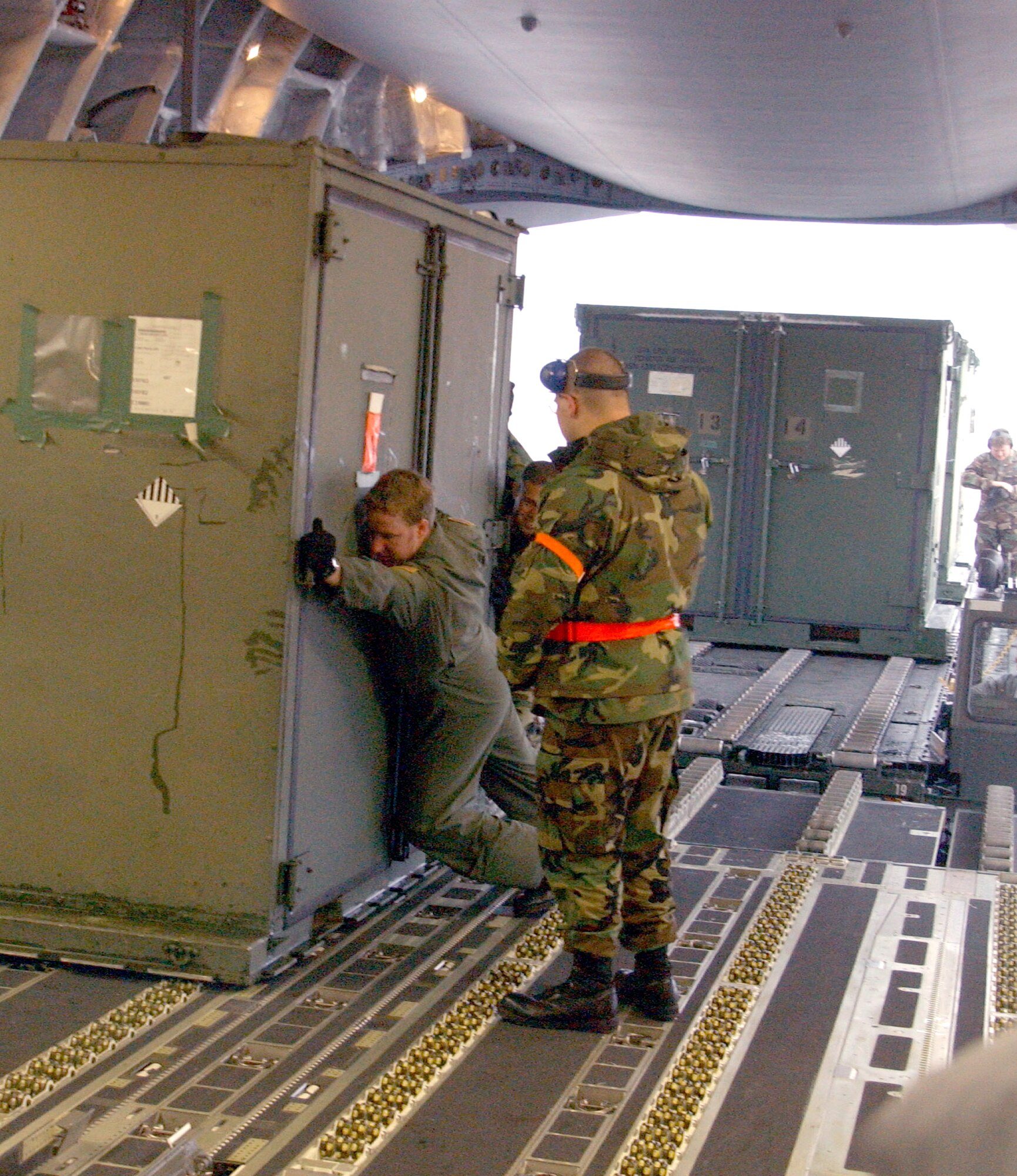 YOKOTA AIR BASE, Japan -- Airmen from the 374th Airlift Wing load supplies onto a C-17 Globemaster III here Dec. 31.  The aircraft is headed for a forward-operating base in Utapao, Thailand.  The supplies are intended to help other Airmen conduct missions supporting tsunami relief efforts in Thailand, Indonesia, Sri Lanka and India.  About 170 Airmen from here have also deployed to support relief operations throughout the region. (U.S. Air Force photo by 1st Lt. Warren Comer)