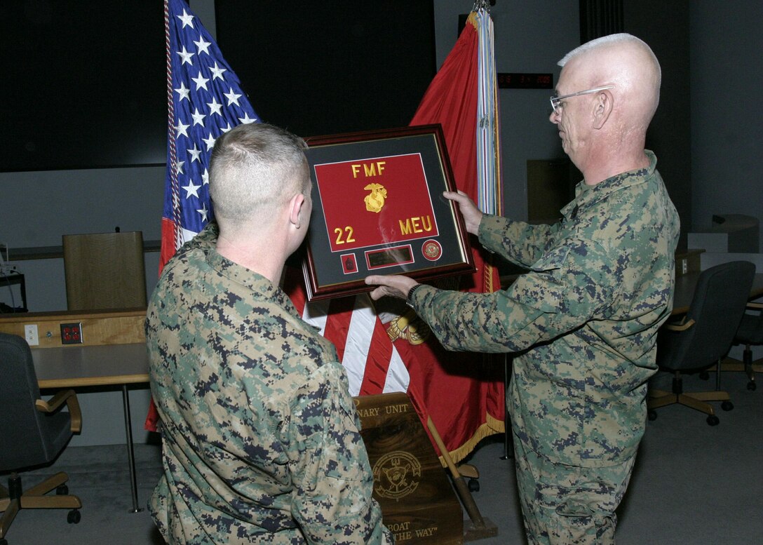 Sgt. Maj. George H. Mason examines a momento given to him by members of the 22nd Marine Expeditionary Unit during his post and relief ceremony aboard Camp Lejeune, N.C., March 4, 2004.  Mason, who will assume the senior enlisted position for the 2nd Marine Aircraft Wing, relinquished his post to Sgt. Maj. Steven R. Head, formerly of the 8th Communications Battalion.