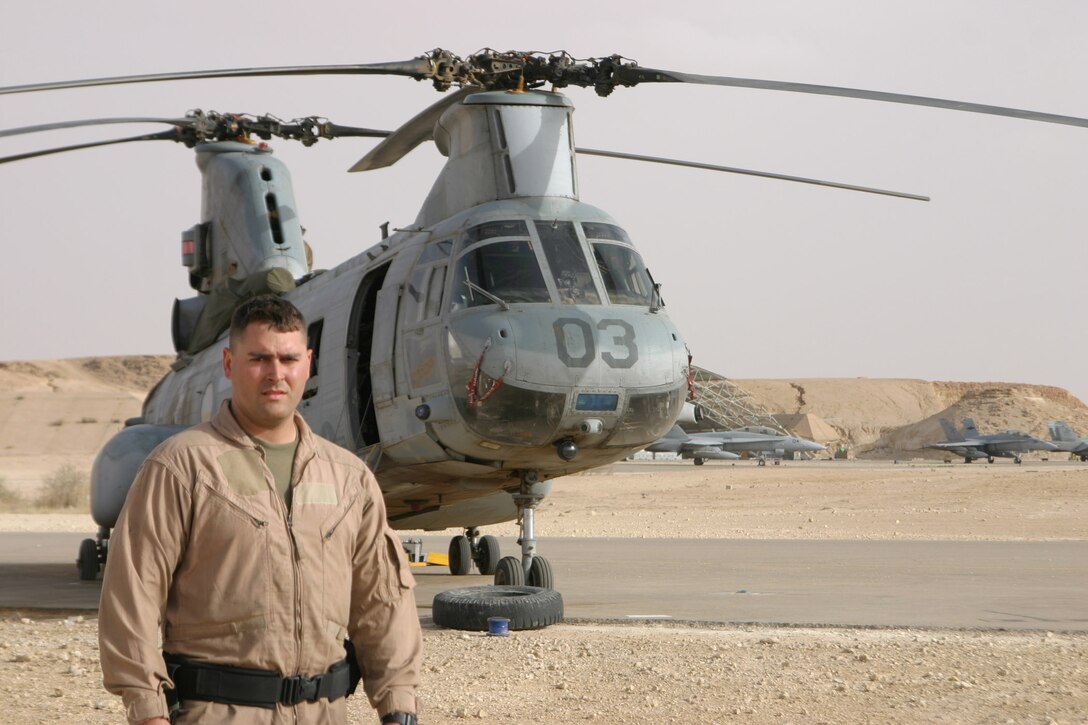 Sergeant Timothy Stickel, crewchief, Marine Medium Helicopter Squadron 264 poses in front of his aircraft after a flight aboard his CH-46E.