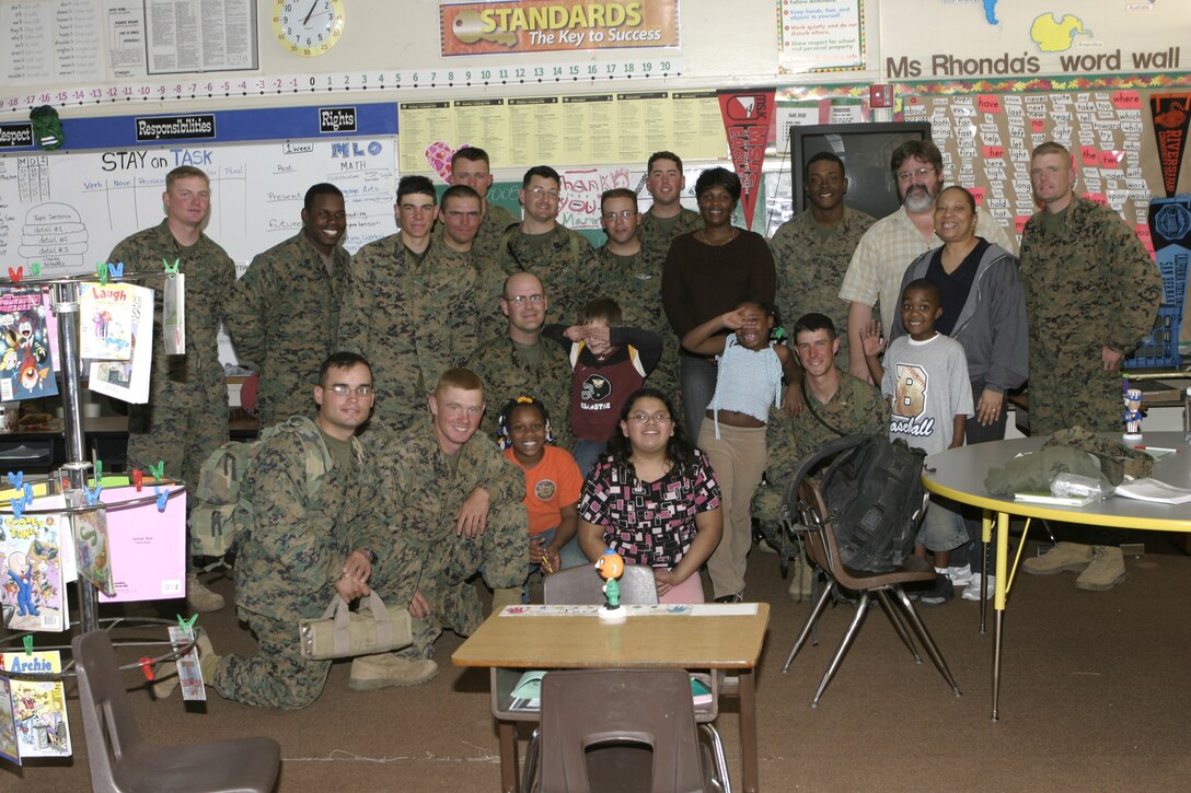 RIVERSIDE, Calif. - Marines and sailors with the Camp Lejeune, N.C.-based infantry unit 1st Battalion, 6th Marine Regiment pose for a group photo with K-5 Arnold Heights alternative school students.  The troops had spent a week conducting pre-deployment field training aboard March Air Reserve Base here, and ended their exercise by speaking to kids about the values of honor, courage, commitment and staying in school.  Photo by: Cpl. Mike Escobar