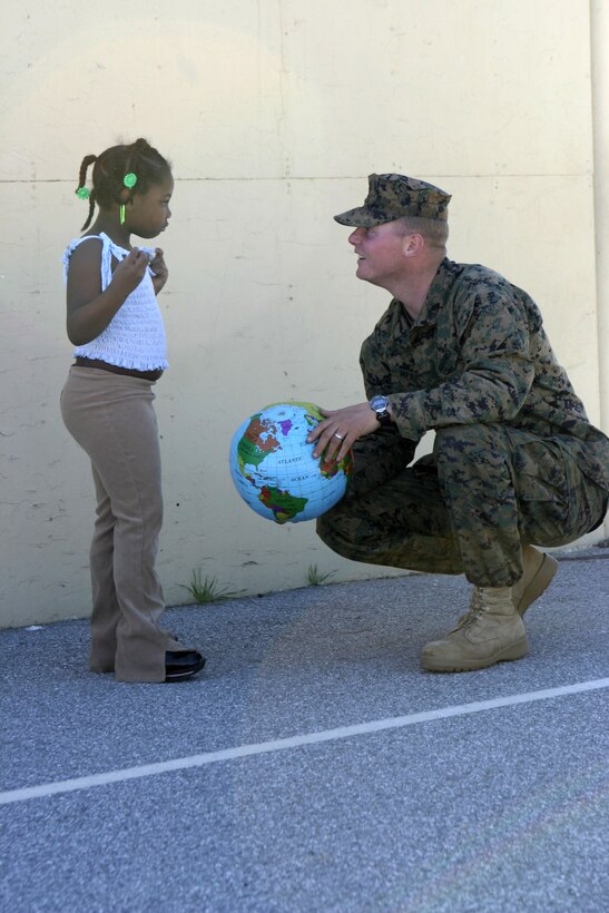 RIVERSIDE, Calif. - A Marine with 1st Battalion, 6th Marine Regiment speaks with an Arnold Heights alternative school student shortly after a game of handball with a globe-shaped ball.  1/6 personnel had spent a week conducting pre-deployment field training aboard March Air Reserve Base here, and ended their exercise by speaking to kids about the values of honor, courage, commitment and staying in school.  Photo by: Cpl. Mike Escobar