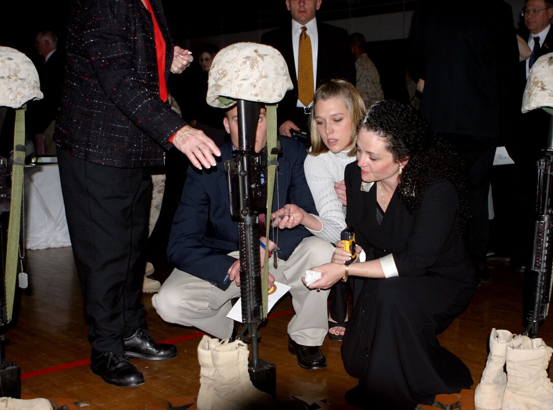 050304-M-2607O-001 MARINE CORPS BASE CAMP LEJEUNE, N.C. (March 4, 2005) - Kathleen Faircloth and her family morn the loss of her son Lance Cpl. Bradley M. Faircloth during the 1st Battalion, 8th Marine Regiment, memorial service for their fallen Marines at the Goettege Memorial Field House March 4.  Twenty- one Marines from the battalion paid the ultimate price to keep our county safe.