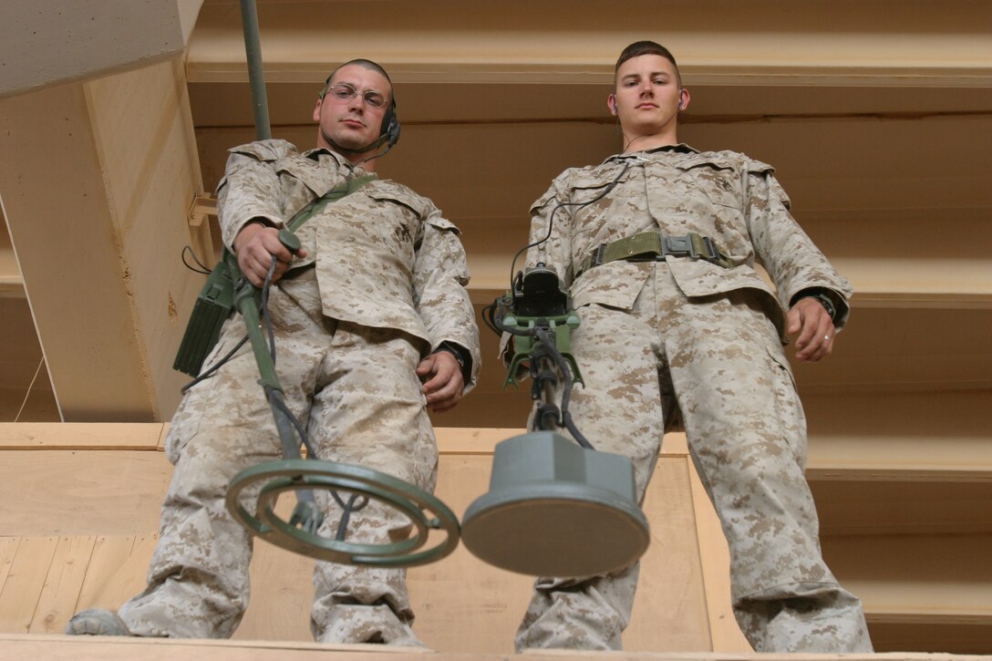 CAMP AL QA'IM, Iraq (June 6, 2005)- Lance Cpl. Matthew R. Pett, 27, (left) and Cpl. Christopher N. Blount, 22, both natives of Charleston, W.Va., and combat engineers with Company A, 4th Combat Engineer Battalion, Task Force 3/2, Regimental Combat Team-2 collectively found six weapons caches north of the Euphrates River during Operation River Round-Up in the Al Qa'im region June 4. Official U.S. Marine Corps photo by Lance Cpl. Lucian Friel (RELEASED)