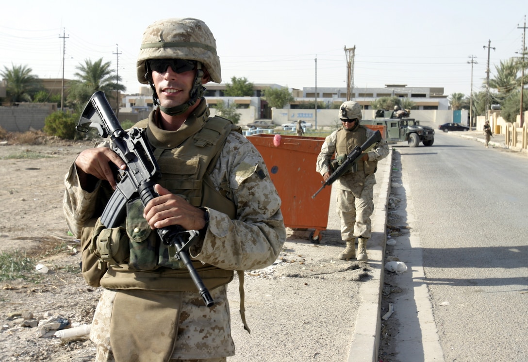 FALLUJAH, Iraq - Sergeant Steven Miller, an infantryman with 4th Combined Anti-Armor Team, Weapons Company, 1st Battalion, 6th Marine Regiment, patrols the city streets beside his fellow Marines.   Fourth CAAT Marines routinely patrol Fallujah's streets aboard their armored trucks and on foot to deter insurgent activity and interact with the community.