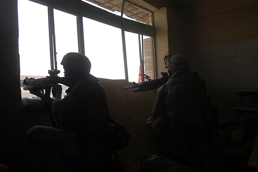 Hit, Iraq (September 4, 2005)-- Marines from Company "I", 3rd Battalion, 25th Marines respond to an attack by insurgents who disrupted civilians receiving money from multinational forces damaged a bridge, caused more than 40 WIAs, one KIA for multinational forces and eight civilian casualties. (Official USMC Photo by Corporal Ken Melton)