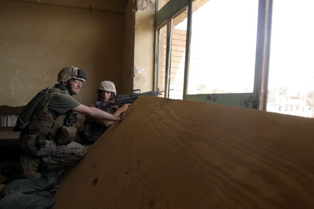 Hit, Iraq (September 4, 2005)-- Marines from Company "I", 3rd Battalion, 25th Marines respond to an attack by insurgents who disrupted civilians receiving money from multinational forces damaged a bridge, caused more than 40 WIAs, one KIA for multinational forces and eight civilian casualties. (Official USMC Photo by Corporal Ken Melton)