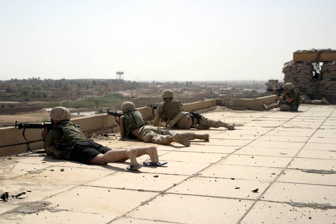Hit, Iraq (September 4, 2005)-- Marines from Company "I", 3rd Battalion, 25th Marines respond to an attack by insurgents who disrupted civilians receiving money from multinational forces damaged a bridge, caused more than 40 WIAs, one KIA for multinational forces and eight civilian casualties. (Official USMC Photo by Corporal Ken Melton)