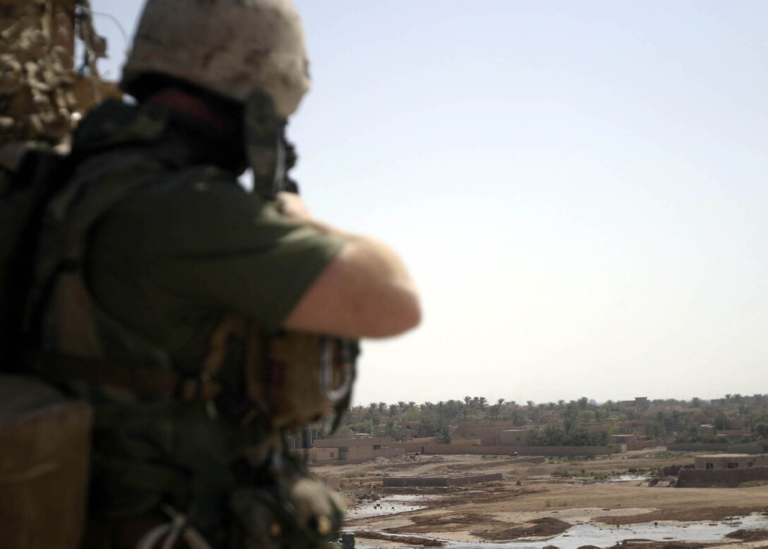 Hit, Iraq (September 4, 2005)-- Marines from Company "I", 3rd Battalion, 25th Marines respond to an attack by insurgents who disrupted civilians receiving money from multinational forces damaged a bridge, caused more than 40 WIAs, one KIA for multinational forces and eight civilian casualties. (Official USMC Photo by Corporal Ken Melton)