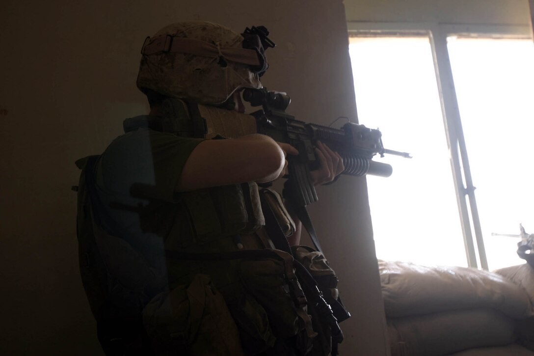 Hit, Iraq (September 4, 2005)-- Marines from Company "I", 3rd Battalion, 25th Marines respond to an attack by insurgents who disrupted civilians receiving money from multinational forces damaged a bridge, caused more than 40 WIAs, one KIA for multinational forces and eight civilian casualties. (Official USMC Photo by Corporal Ken Melton)