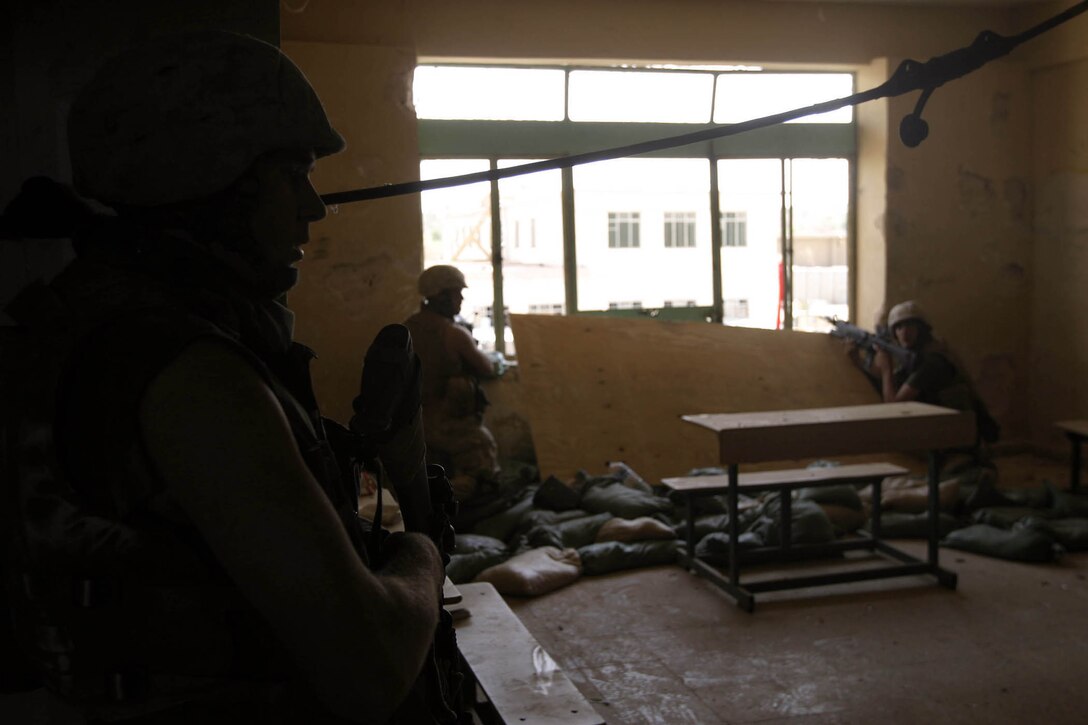 Hit, Iraq (September 4, 2005)-- Marines from Company "I", 3rd Battalion, 25th Marines respond to an attack by insurgents who disrupted civilians receiving money from multinational forces damaged a bridge, caused more than 40 WIAs, one KIA for multinational forces and eight civilian casualties. (Official USMC Photo by Corporal Ken Melton)