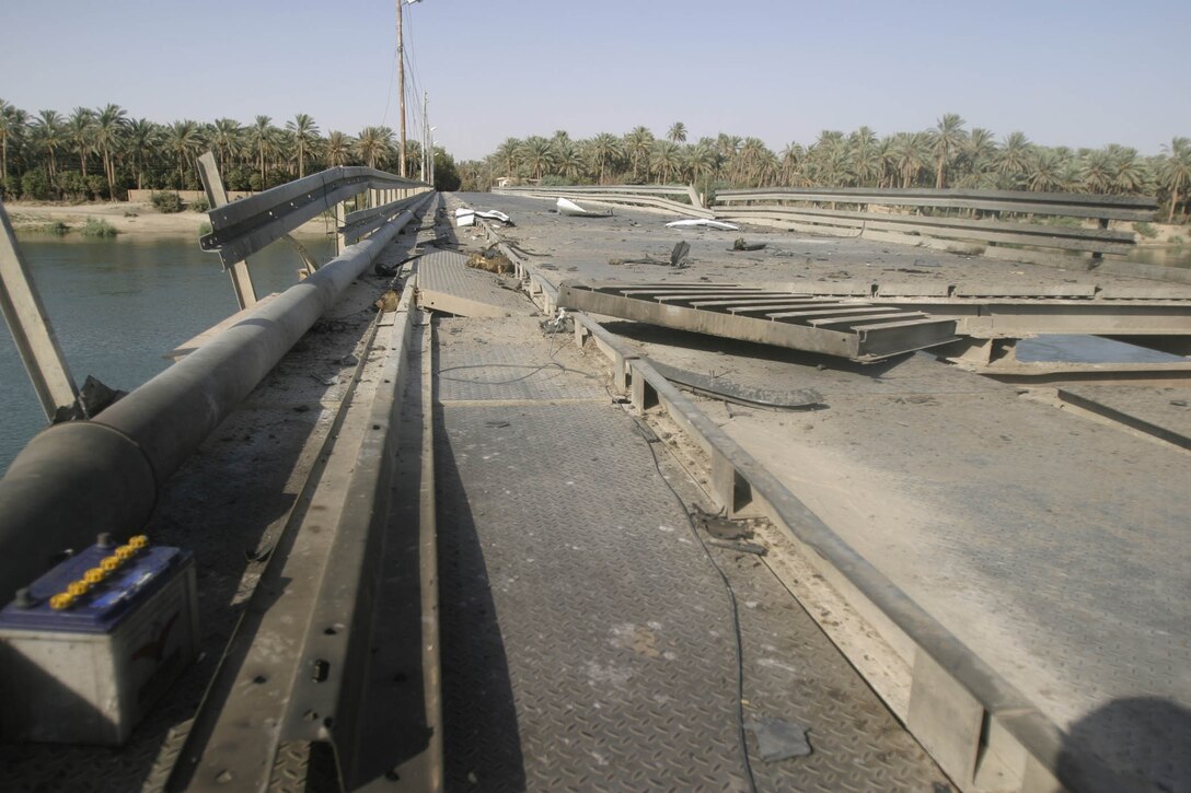 Hit, Iraq (September 4, 2005)-- The damage left by an the SVBIED used in an attack on Company "I", 3rd Battalion, 25th Marines respond to an attack by insurgents who disrupted civilians receiving money from multinational forces damaged a bridge, a caused 18 WIAs, 1 KIA to multinational forces and eight civilian casualties. (Official USMC Photo by Corporal Ken Melton)