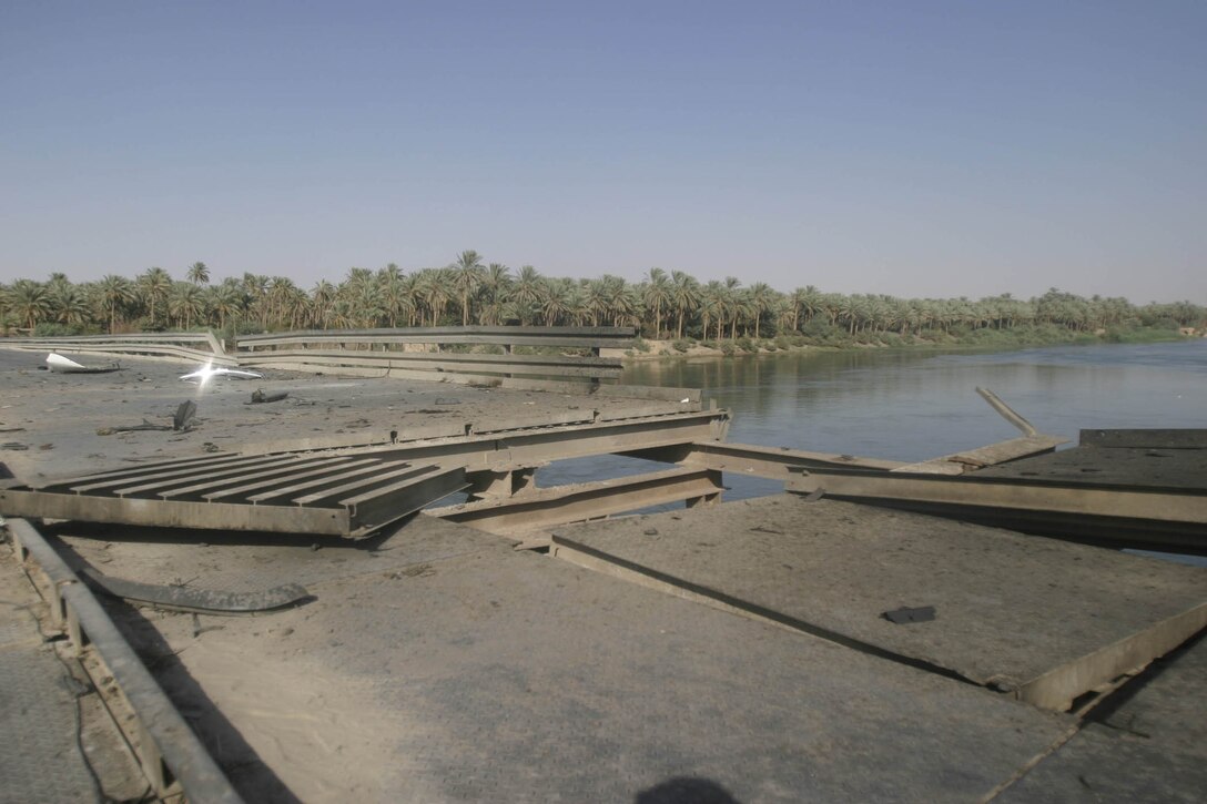 Hit, Iraq (September 4, 2005)-- The damage left by an the SVBIED used in an attack on Company "I", 3rd Battalion, 25th Marines respond to an attack by insurgents who disrupted civilians receiving money from multinational forces damaged a bridge, a caused more than 40 WIAs, 1 KIA to multinational forces and eight civilian casualties. (Official USMC Photo by Corporal Ken Melton)