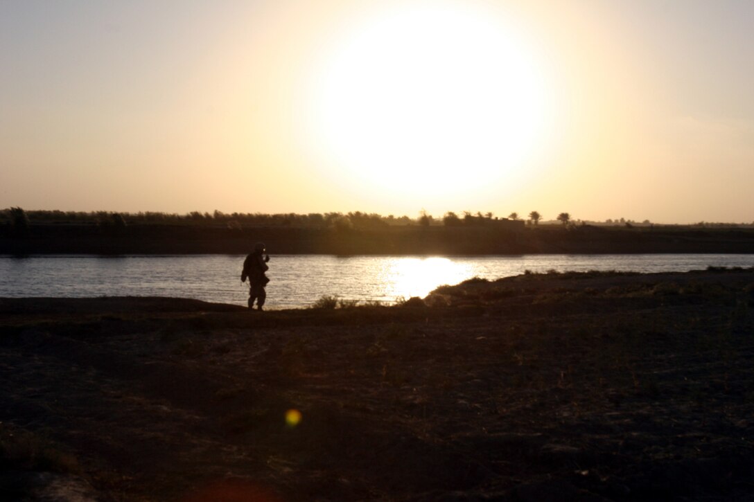 AR RAMADI, Iraq (October 4, 2005) - A Marine patrols near the Euphrates River during Operation Bowie Oct. 4. The operation was a cooperative effort between the Iraqi Security Force, the army and the Marine Corps to capture and disrupt insurgent activities in Ar Ramadi in the weeks leading up to constitutional election. Photo by Cpl. Shane Suzuki