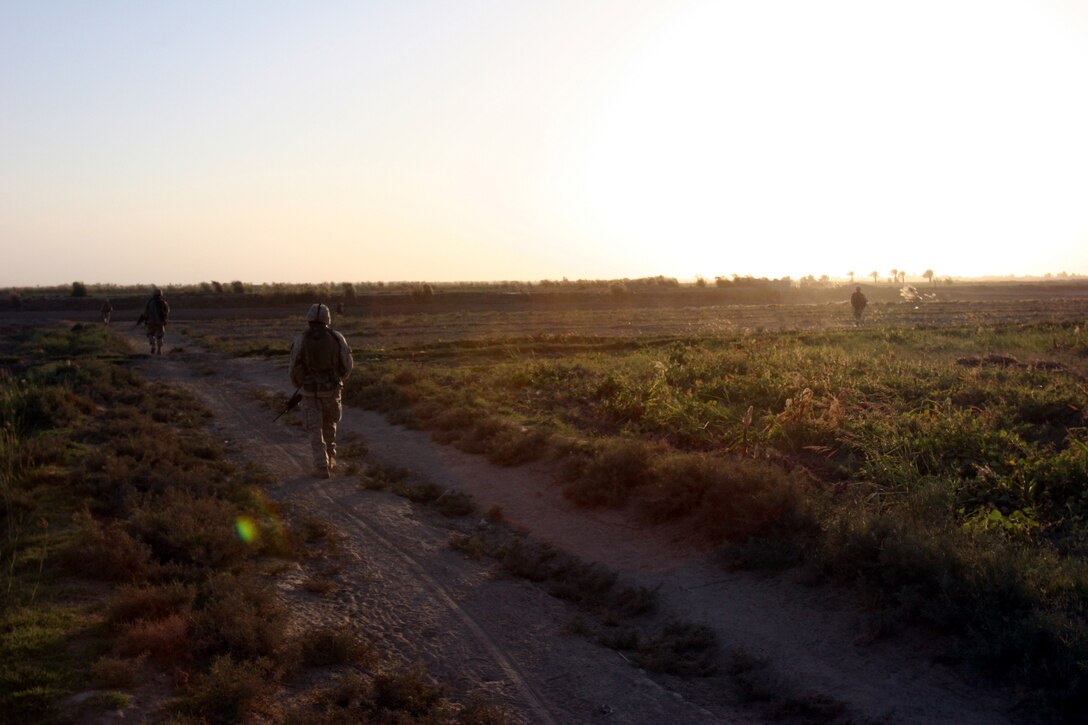 AR RAMADI, Iraq (October 4, 2005) -Marines from Company I patrol through a field in southern Ar Ramadi during Operation Bowie Oct. 4. The operation was a cooperative effort between the Iraqi Security Force, the army and the Marine Corps to capture and disrupt insurgent activities in the city during the weeks leading up to constitutional election. Photo by Cpl. Shane Suzuki