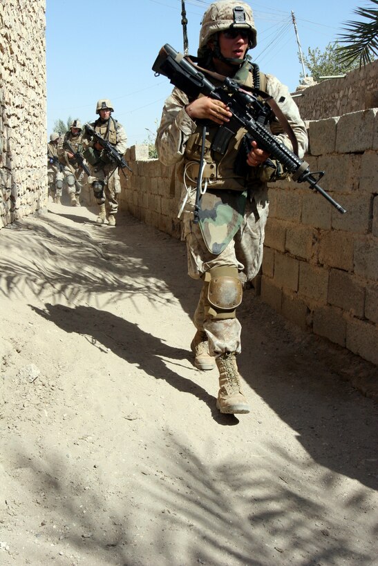 AR RAMADI, Iraq (October 4, 2005) -Marines from Company I on patrol through the streets and alleyways of southern Ar Ramadi during Operation Bowie Oct. 4. The operation was a cooperative effort between the Iraqi Security Force, the army and the Marine Corps to capture and disrupt insurgent activities in the city during the weeks leading up to constitutional election. Photo by Cpl. Shane Suzuki