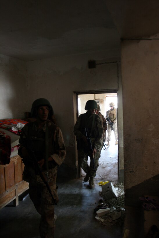 AR RAMADI, Iraq (October 4, 2005) - Members of the Iraqi Security Force secure a home during Operation Bowie Oct. 4. . The operation was a cooperative effort between the Iraqi Security Force, the army and the Marine Corps to capture and disrupt insurgent activities in the city during the weeks leading up to constitutional election. Photo by Cpl. Shane Suzuki