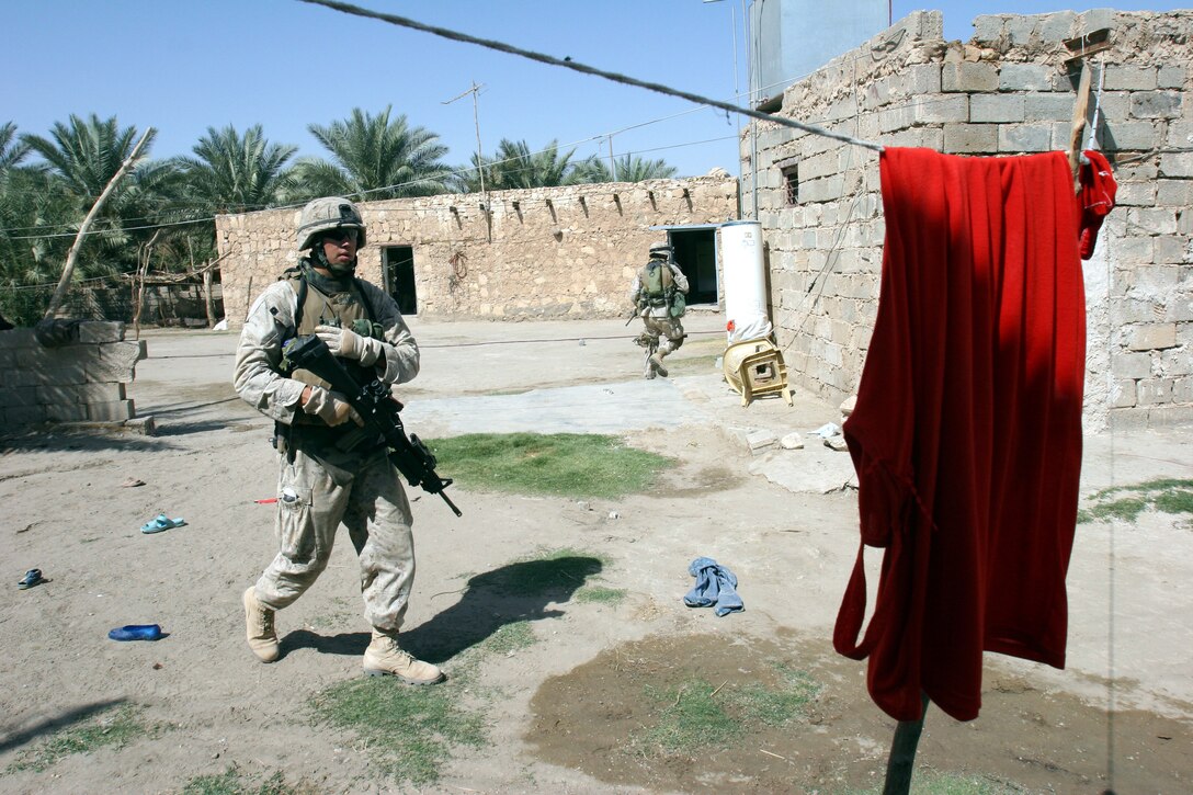 AR RAMADI, Iraq (October 4, 2005) - A Marine from Company I on patrol through the streets and alleyways of southern Ar Ramadi during Operation Bowie Oct. 4. The operation was a cooperative effort between the Iraqi Security Force, the army and the Marine Corps to capture and disrupt insurgent activities in the city during the weeks leading up to constitutional election. Photo by Cpl. Shane Suzuki