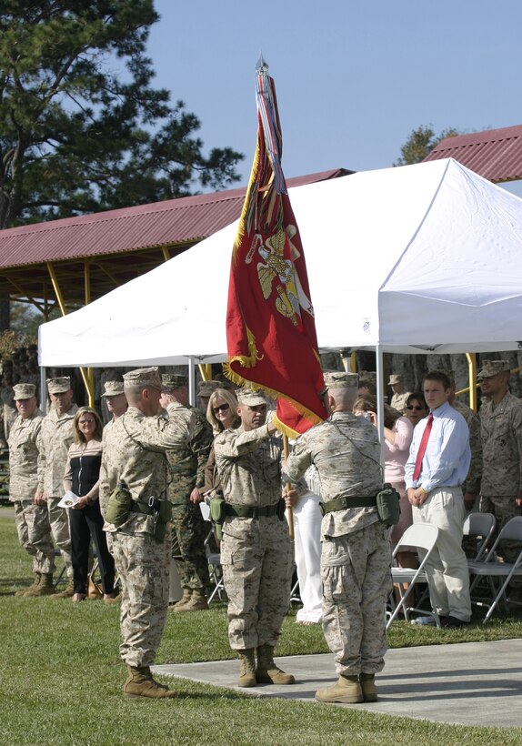 MARINE CORPS BASE CAMP LEJEUNE, N.C. - Lieutenant Colonel Robert G. Petit, left, hands the 2nd Battalion, 8th Marine Regiment colors to Lt. Col. Kenneth M. DeTreux to symbolize the transfer of authority during a change of command ceremony here Nov. 4.  DeTreux, a native of Philadelphia, assumed command of "America's Battalion" to prepare his Marines for a deployment to Iraq in 2006.